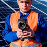 inspector holds infrared camera for home inspection